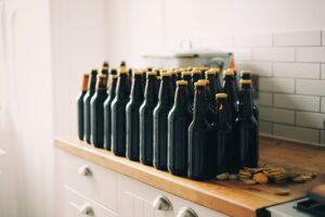 Home brew beer bottle on counter at home where someone has been  making beer