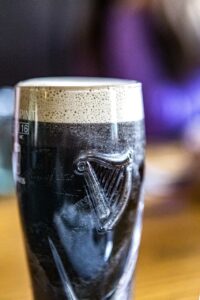 a Guinness beer poured into the iconic harp glass